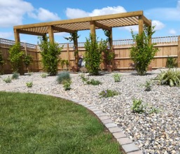 Cobble edging, low maintenance gravel and pergola